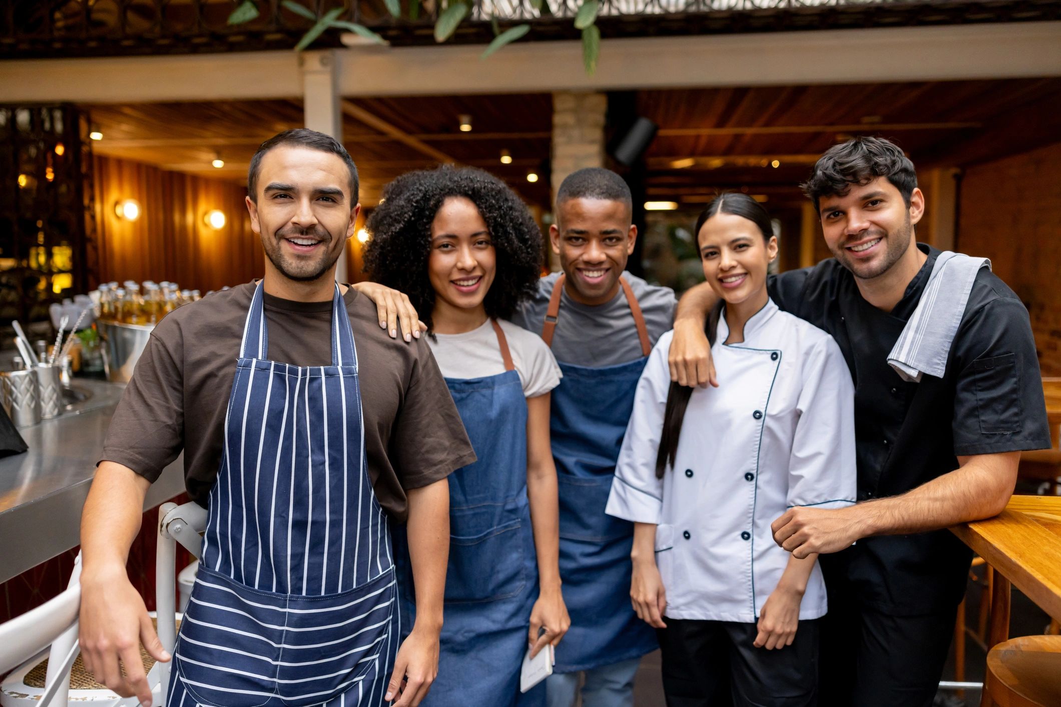 Restaurant workers smile because they qualify for the $25,000 deduction for tips.
