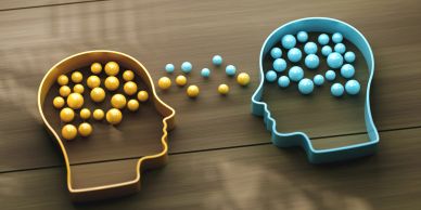 Two head-shaped containers exchanging colored spheres.