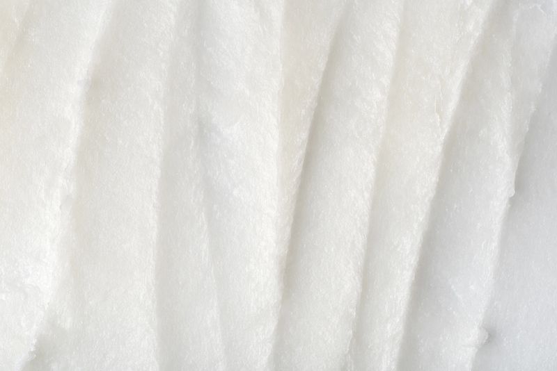 Closeup of solid white coconut oil with rich, creamy texture. Natural organic skincare or culinary ingredient. Ideal for wellness, beauty, and cosmetic product design.