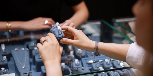 Two people examining rings at a jewelry store.