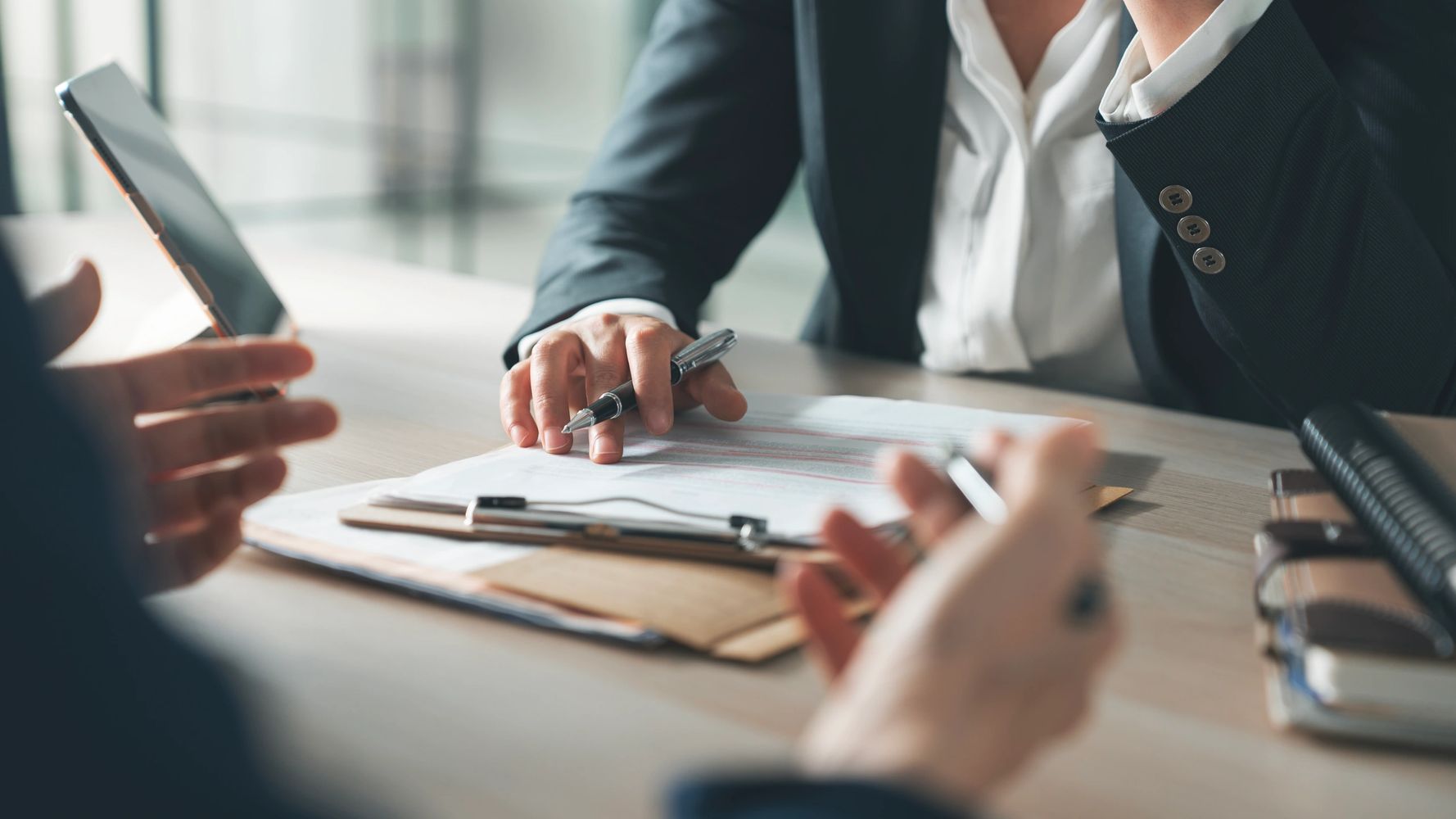 Two people discussing documents at a meeting.
