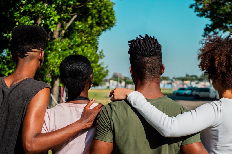 Young friends walking on public park