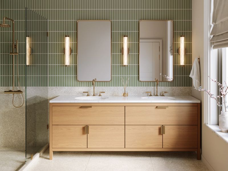 3d render - a modern bathroom with green wall tile and terrazzo wall and floor tile, brass plumbing fixtures , brass mirrors and marble countertop	. An eclectic luxurious design