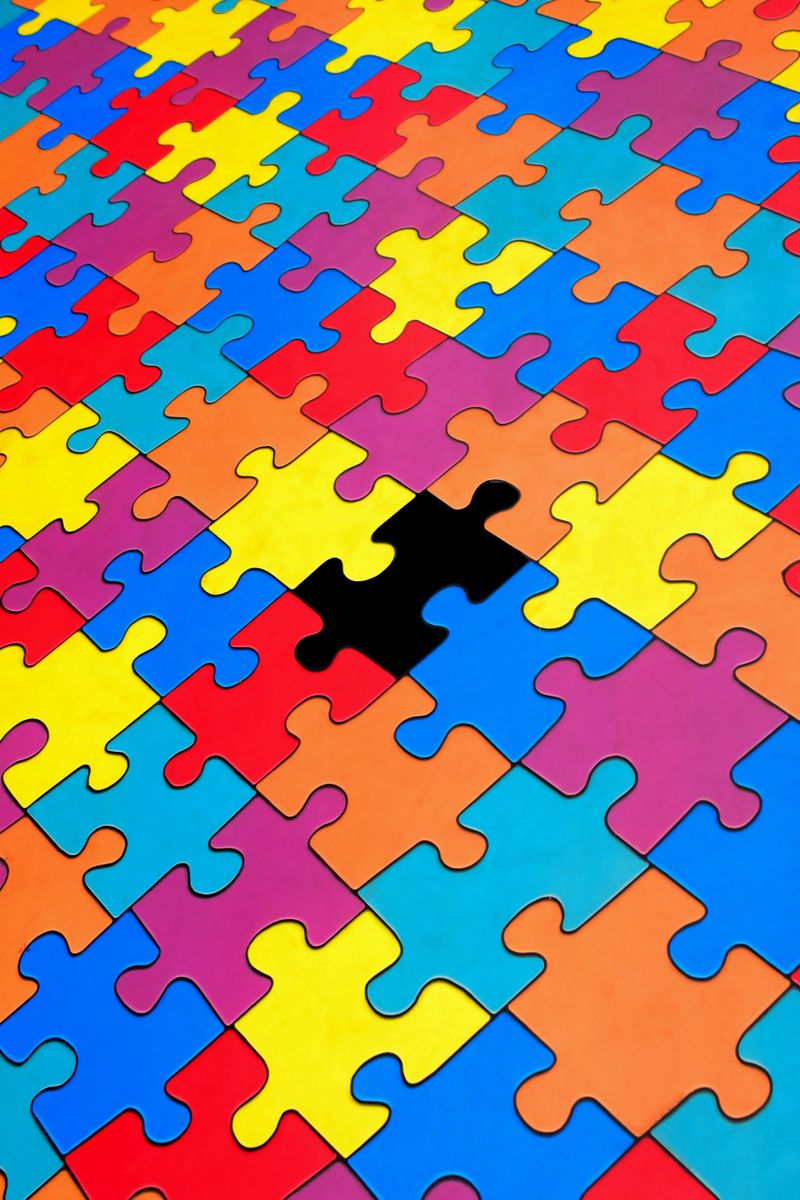 Missing piece in colorful jigsaw puzzle – concept of incompleteness or solution needed