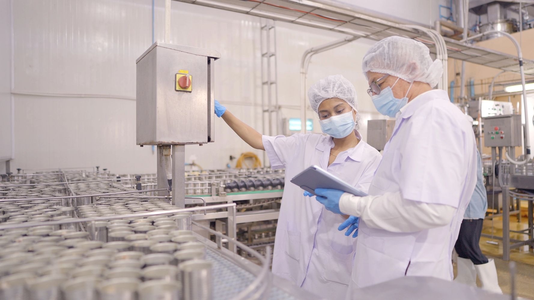 Stack of books next to pencils in a holder and a camera.