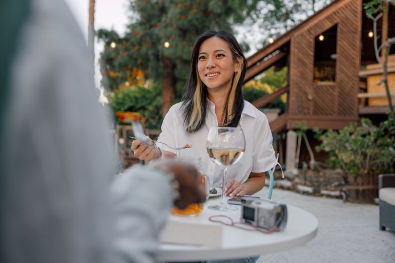 Fine dining, two women eating outdoors and celebrate their friendship.