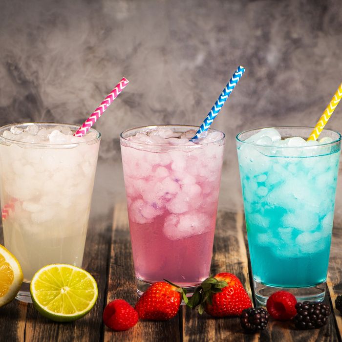 Three lemonades: one plain lemonade to the left, one pink lemonade in the middle, and a blue lemonad