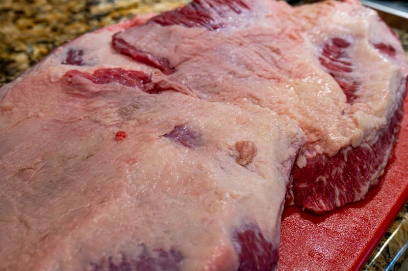 Trimming the fat and separating the flat and point of a brisket