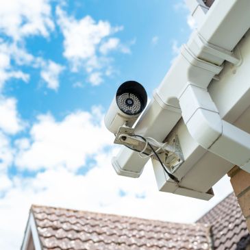 Security camera mounted on house roof.