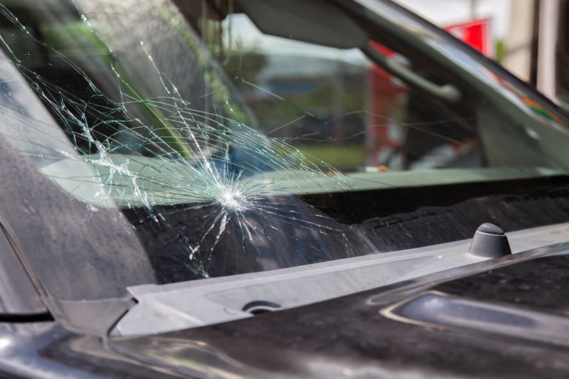 Car waiting for windshield replacement at auto repair shop