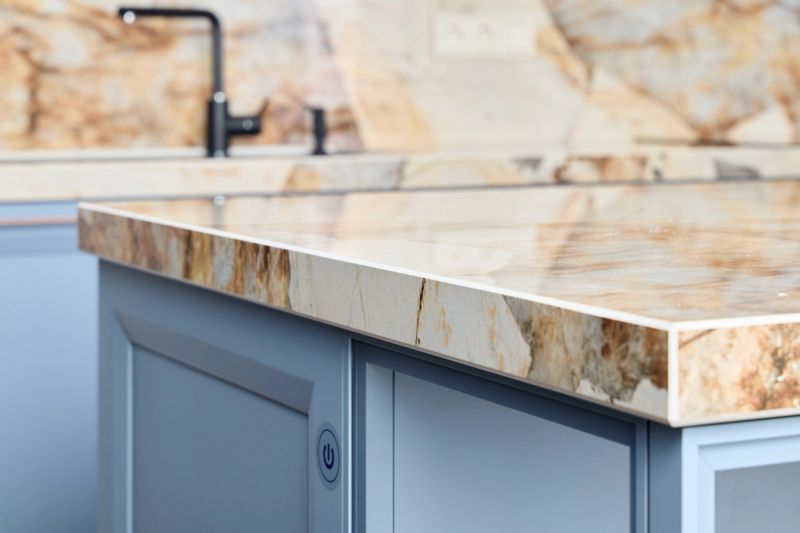 A sleek and stylish kitchen island that showcases a stunning marble countertop paired with modern cabinetry