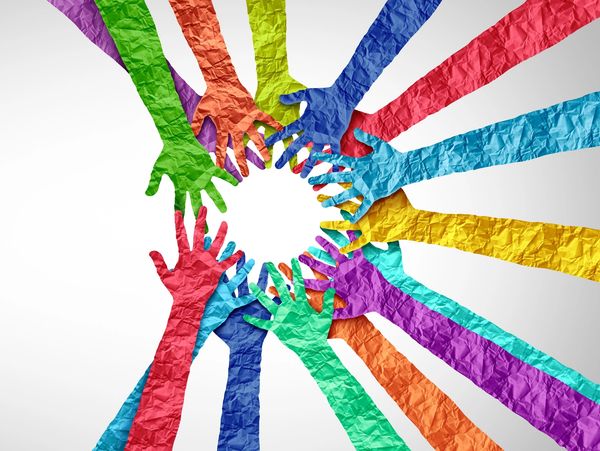 Colorful paper hands reaching towards the center in a circle.