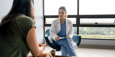Doctor consulting with a patient in a bright room.