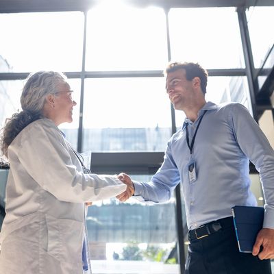 ALERT=" A PROVIDER IS SHAKING HAND WITH A NEW EMPLOYEE"