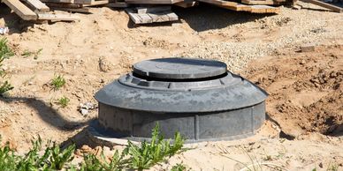 Septic tank riser installed at grade for a home septic system upgrade