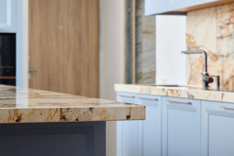 This contemporary kitchen proudly showcases a luxurious granite countertop paired with sleek cabinetry design