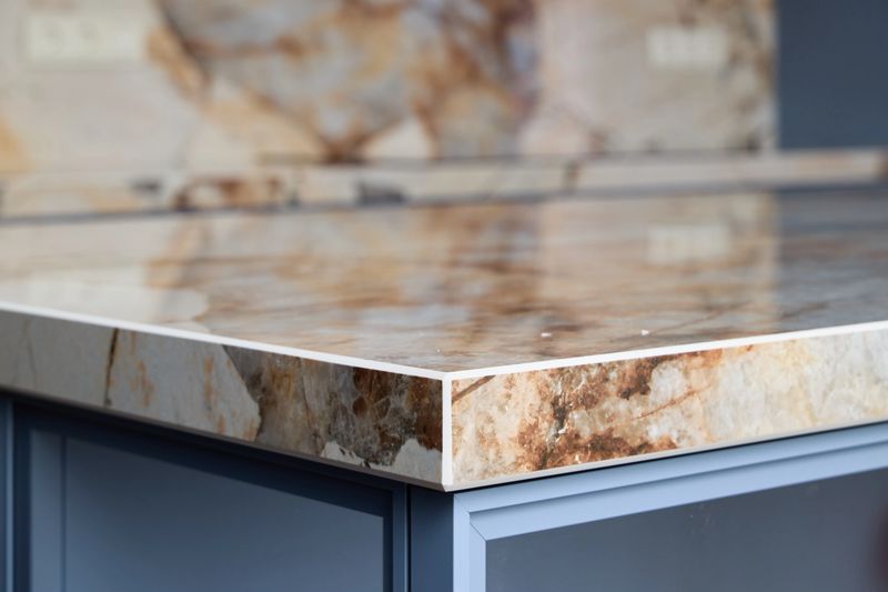 This stylish kitchen countertop showcases the beauty of natural stone adorned with intricate and captivating patterns
