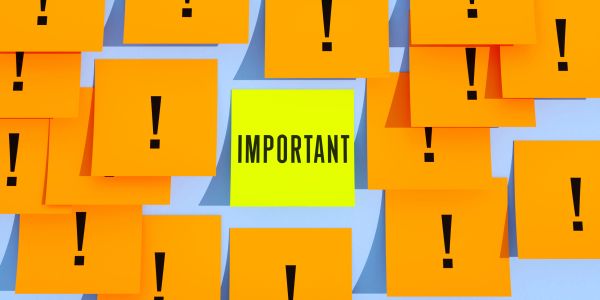 Yellow sticky note with 'IMPORTANT' among orange notes with exclamation marks.