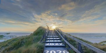 Wooden stairway to beach with years leading to sunrise.