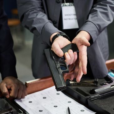 A person demonstrating gun safety while holding a handgun.