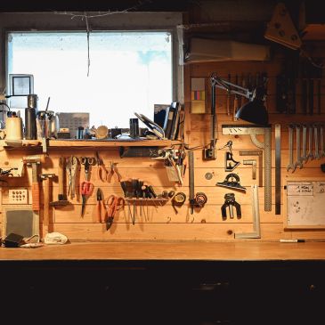Organized woodworking tools neatly arranged on a wall.