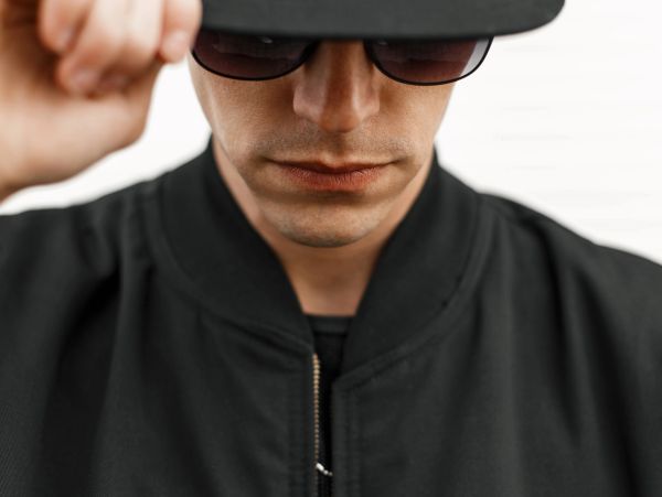 Man wearing sunglasses and a cap.