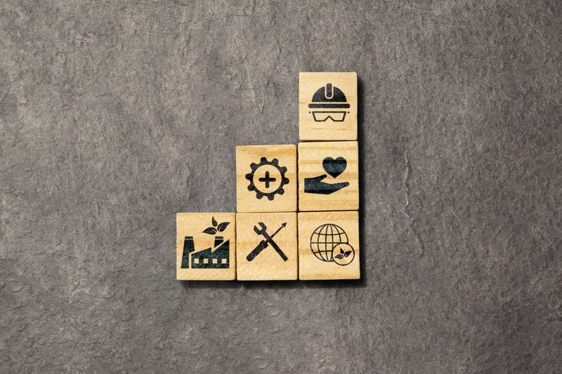 Wooden cubes with an HSE sign on a black background. Abbreviation of Health, Safety, and Environment. Industry standardization of a safe, healthy, and good environment