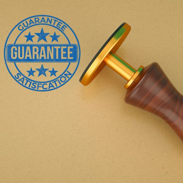 A stamp guaranteeing satisfaction with a wooden handle.