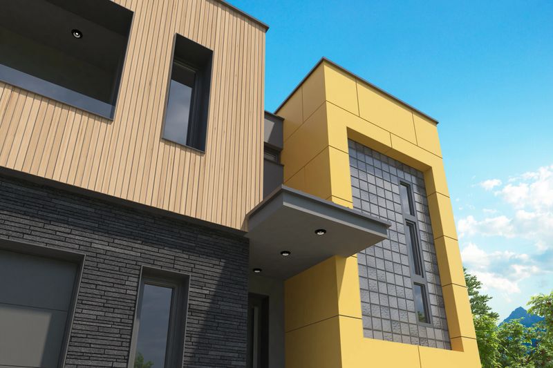 Stylish and modern two-story house with a flat roof, captured on a sunny summer day. The ground floor features a striking black slate stone facade with large garage doors and a clean entrance. The upper floor showcases vertical wooden slats in Scandinavian style, complemented by a prominent HPL-panelled staircase cube. Large modern windows and a minimalist front garden with driveway enhance the overall sleek and elegant look. Ideal for use in architecture portfolios, facade design concepts, modern housing promotion, real estate listings, and exterior design inspiration.