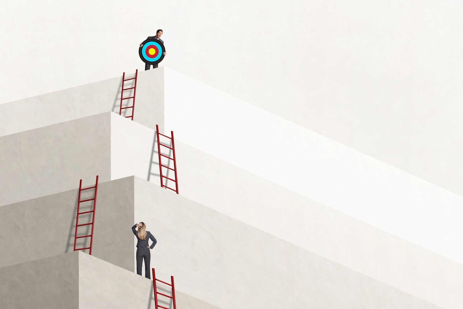 A businessman holds a target atop stairs while a businesswoman looks up, puzzled.