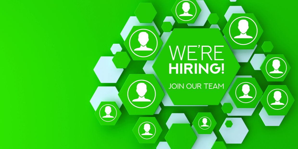 Green hiring sign with user icons saying "We're Hiring".