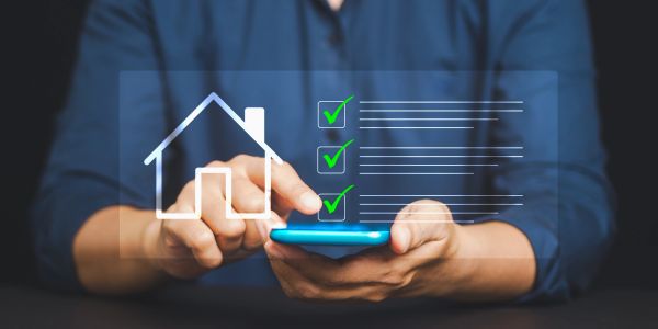 Person using smartphone with a digital house checklist overlay.
