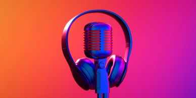 Retro microphone and headphones with vibrant lighting.