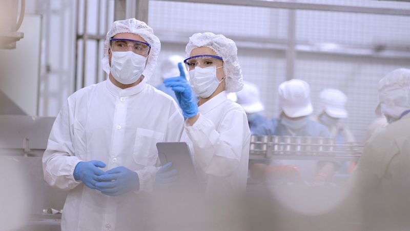 Engineers consulting on wood manufacturing production line