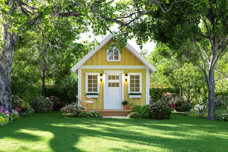 Cute tiny yellow house on green lawn 3d render Surrounded by nature.