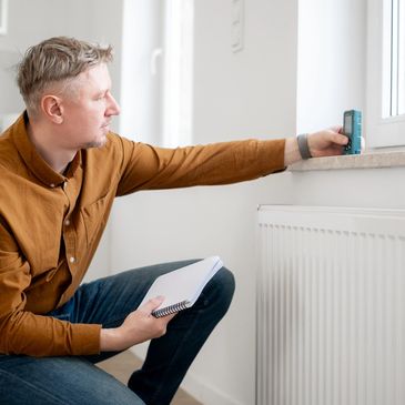 Appraiser measuring indoor wall distance.