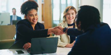 Business handshake in office meeting.