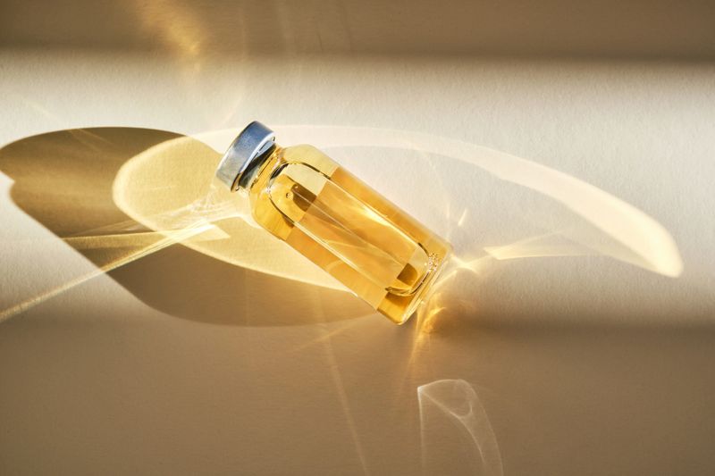 Injection vial in sunlight on beige background. High quality photo.