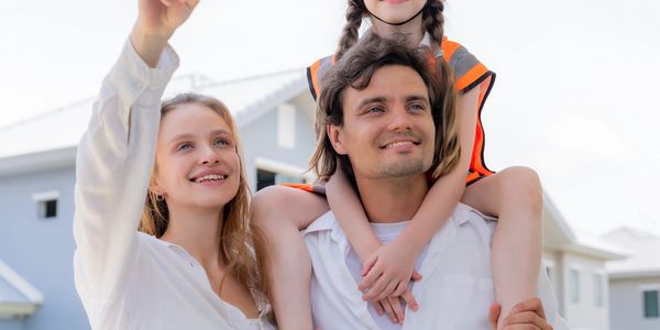 Happy family enjoying a moment outside their new home.