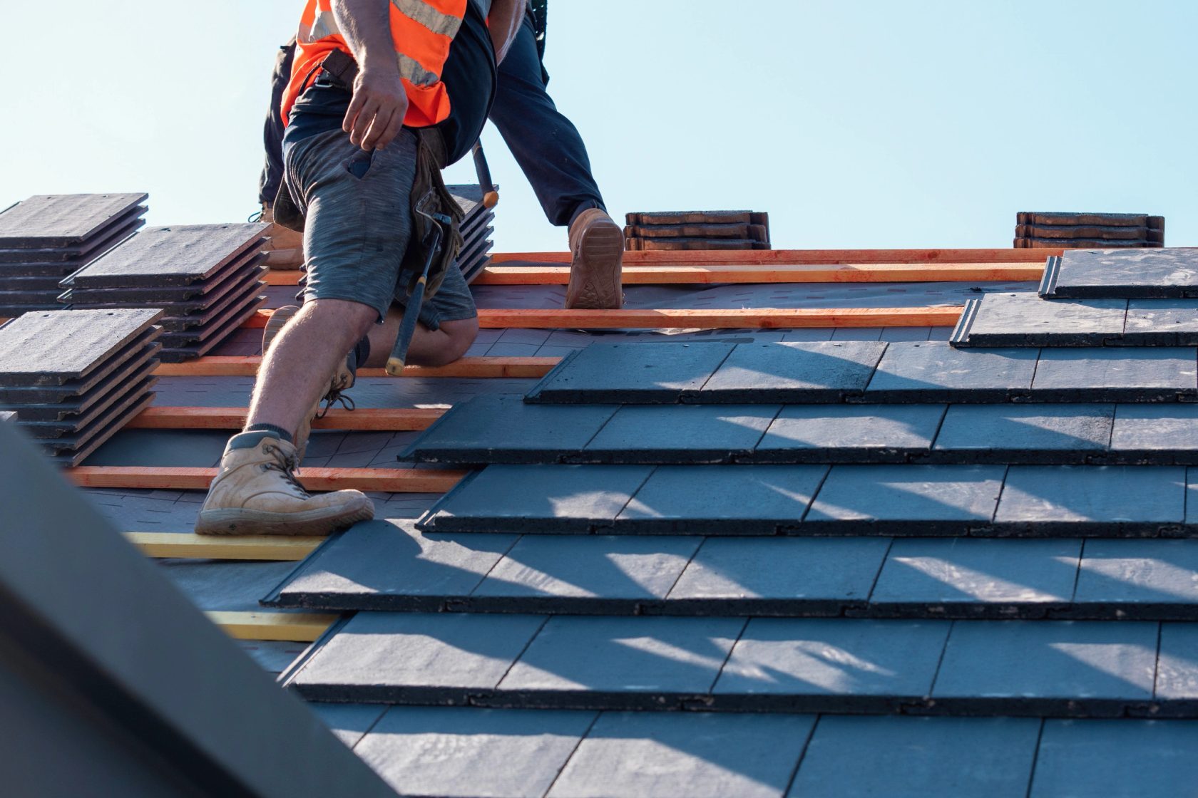 Craftsman installing tile roofing on copper battens