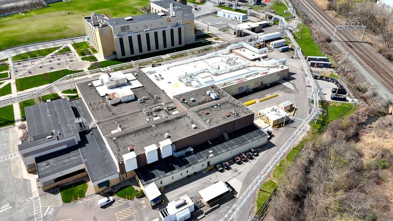 Aerially changing position over a facility that operates for the purpose of handling manufacturing for both clinical trials and commercial drug launches