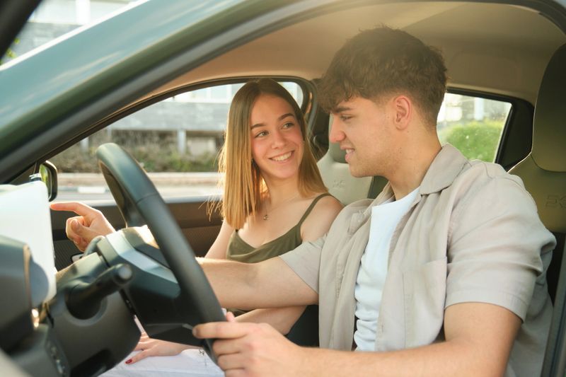 Young couple navigating their electric vehicle, embracing eco-friendly travel