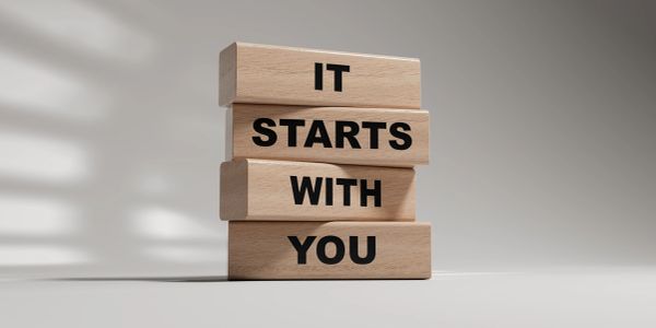 Wooden blocks with 'IT STARTS WITH YOU' text.