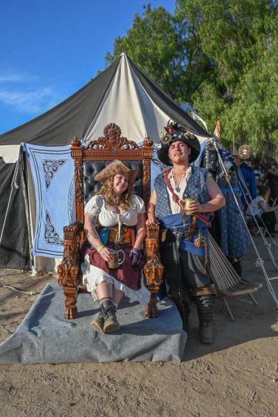 Two people dressed as pirates at a renaissance fair.
