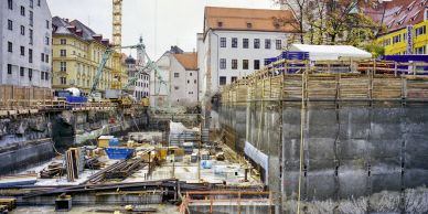 Construction site with cranes and buildings.