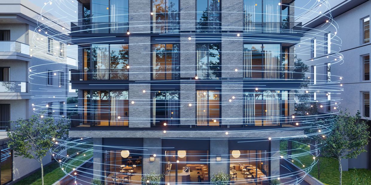 Modern building with digital light swirl effects around it.