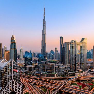 Cityscape with Burj Khalifa at sunset in Dubai.