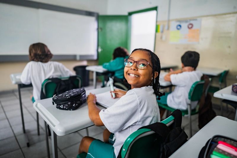 Portrait of a schoolgirl studying in the classroom at school