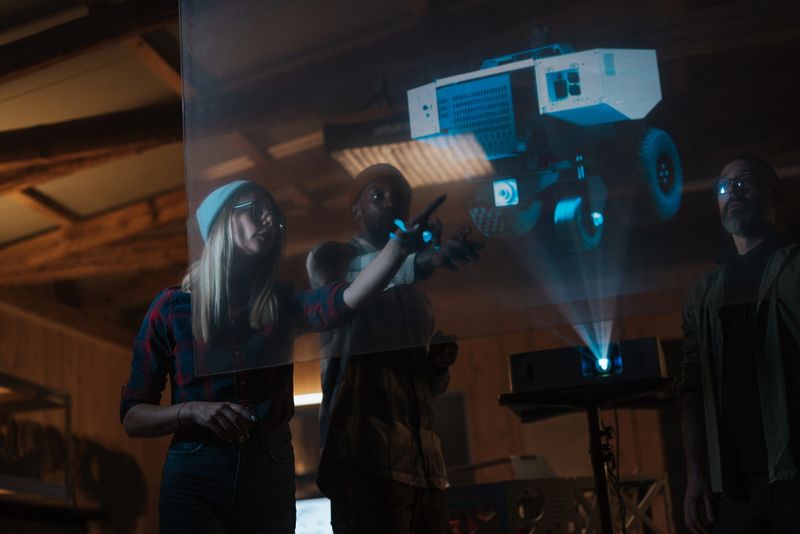 Engineers collaborating on futuristic rover design, using holographic projection for innovative development