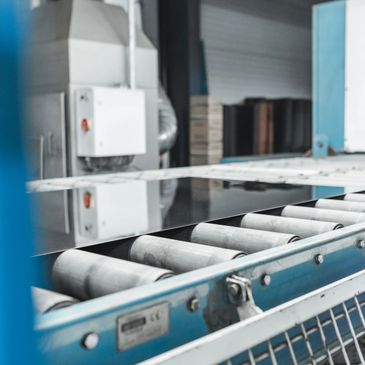 Close-up of an industrial conveyor belt in a factory setting.